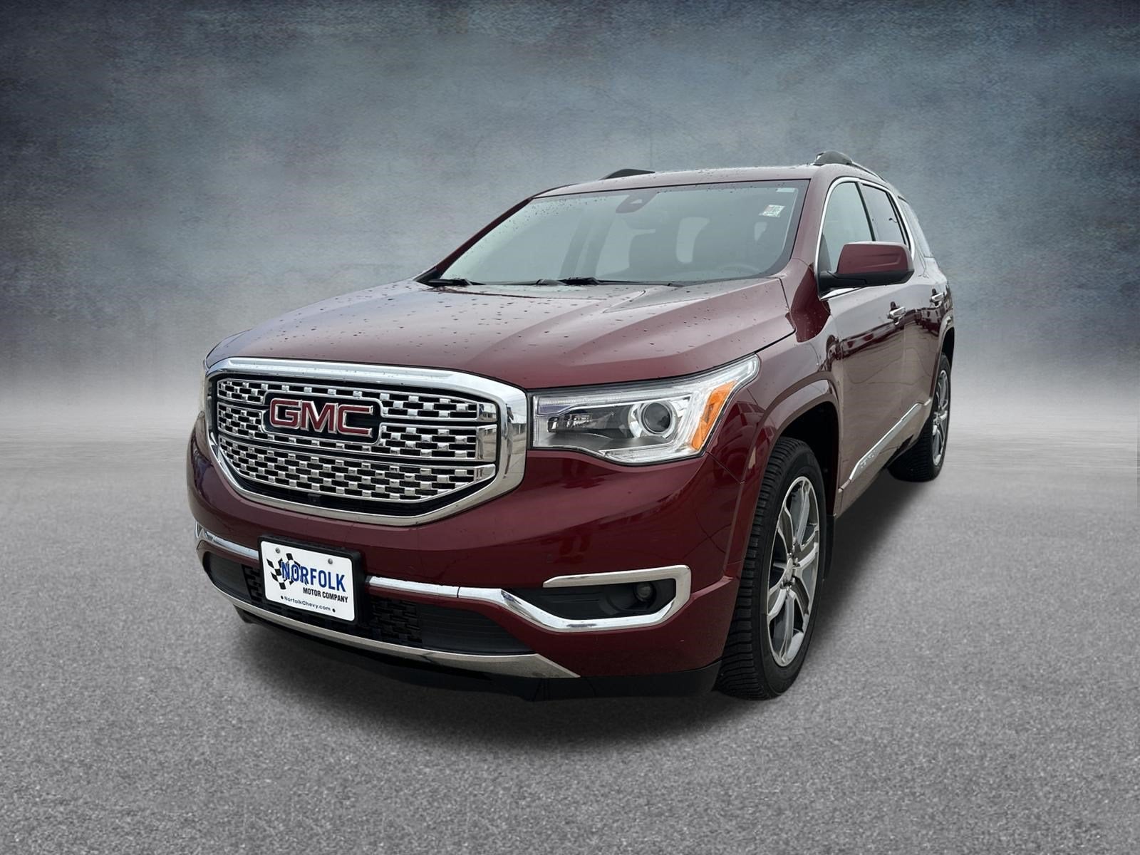 2017 GMC Acadia Denali in Crimson Red Tintcoat — front three-quarter view